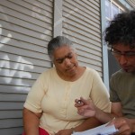 Green Light New Orleans founder Andreas Hoffman, right, explains the efficiency of using CFL bulbs to a recipient.