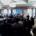 Michael Hecht, CEO and GNO, Inc. addresses the audience at the IP Building in New Orleans, flanked by Governor Bobby Jindal, Mayor Mitch Landrieu and Senator David Vitter.